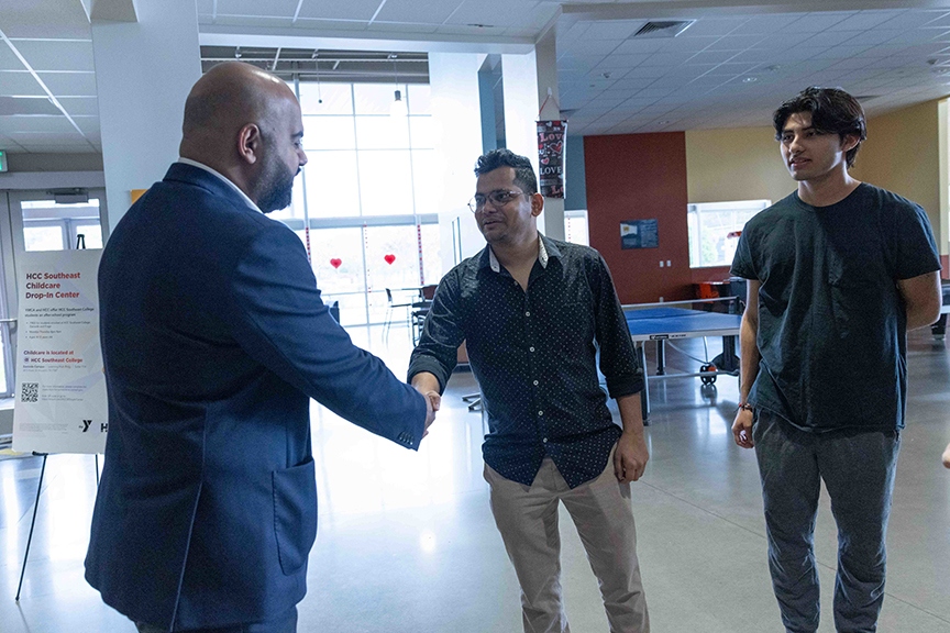 Ahmed Mejairan greets HCC students during his visit.