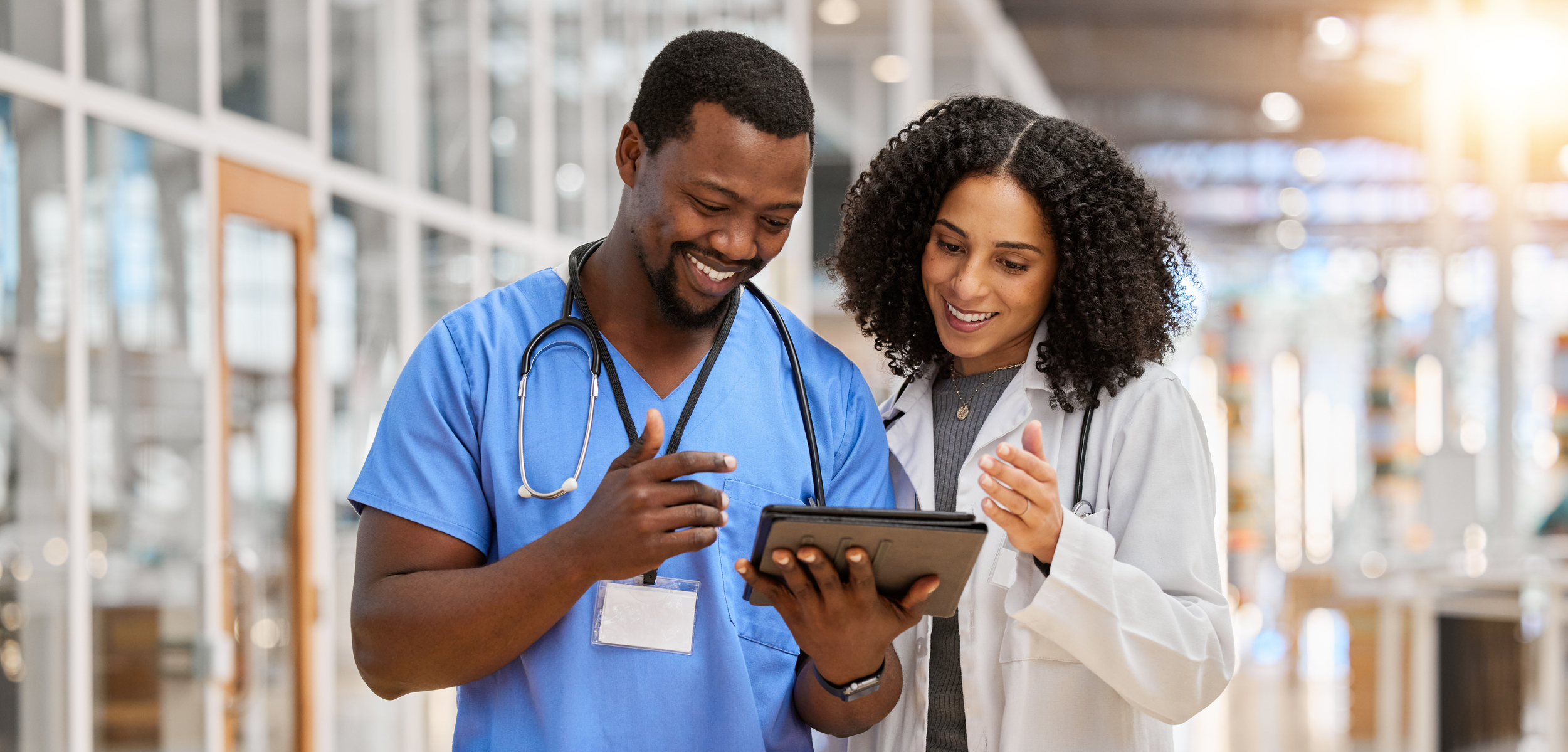 2 Healthcare professionals viewing a tablet