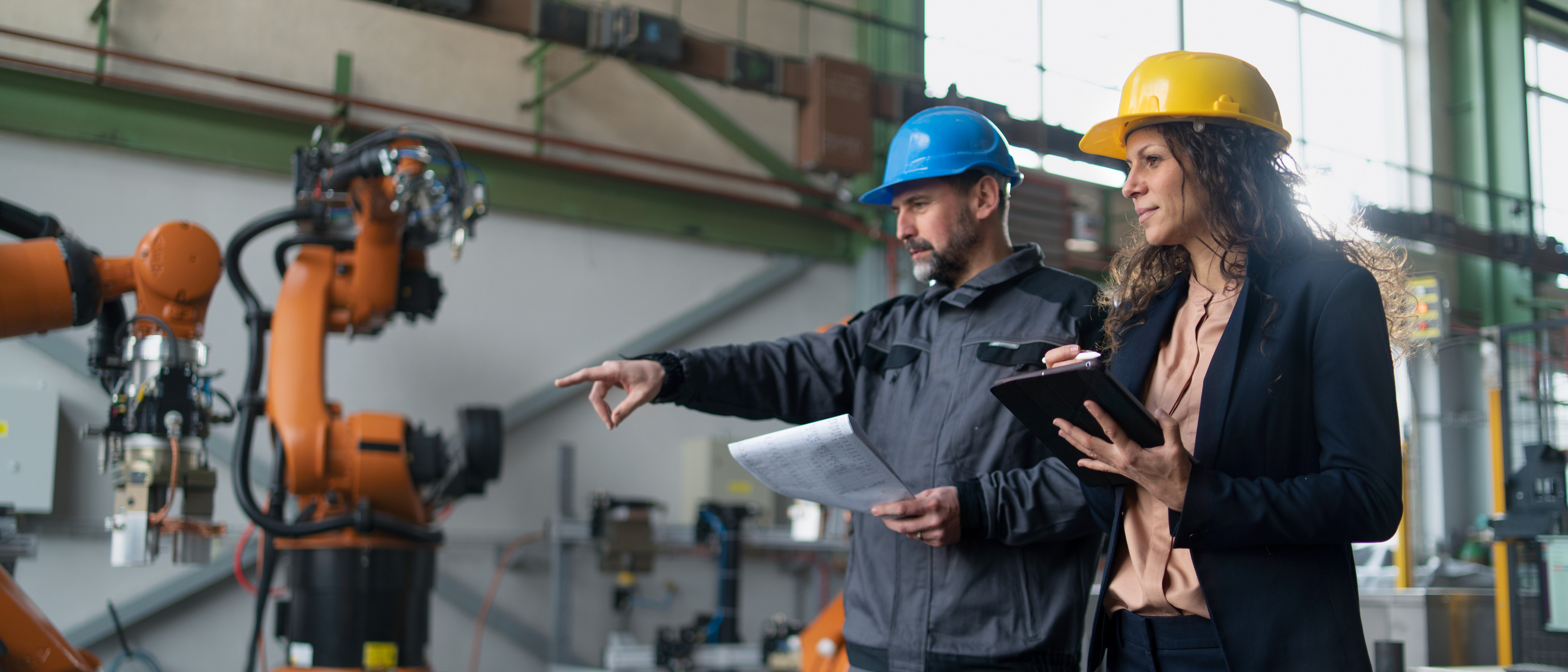 2 Manufacturing Engineers examining manufacturing equipment