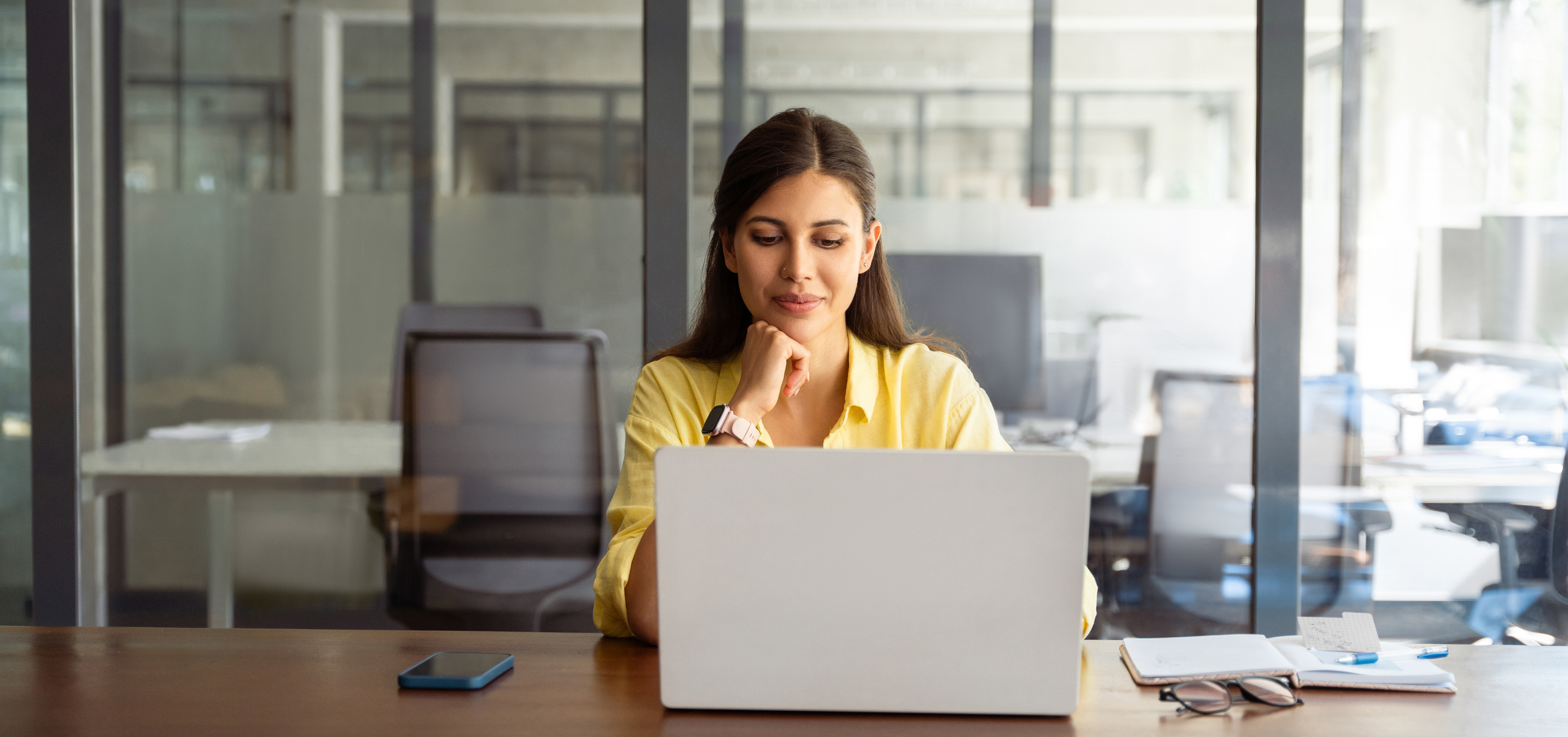 Young female business professional sitting in front of her laptop
