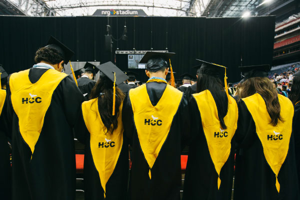 Group of HCC student graduates showing off their chords