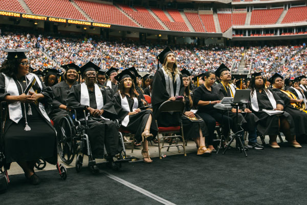 Group of HCC students sitting at graduation