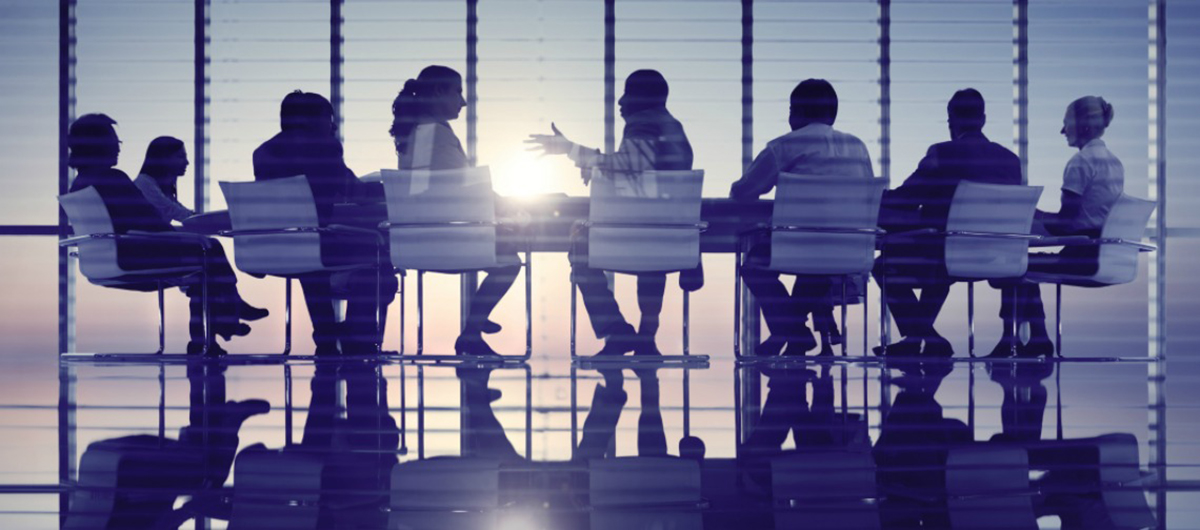 Business executives meeting around a large conference table